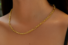 Load image into Gallery viewer, Gold chain necklace on a person's neck with a blurred background