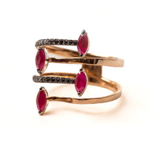 Load image into Gallery viewer, A gold-colored ring with multiple bands, featuring red gemstones and smaller white stones set along the bands.