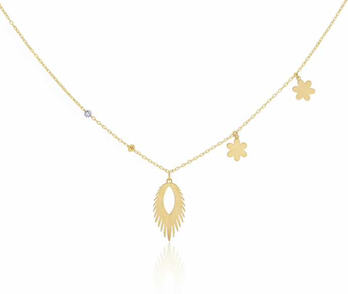 Gold necklace with various pendants on a white background