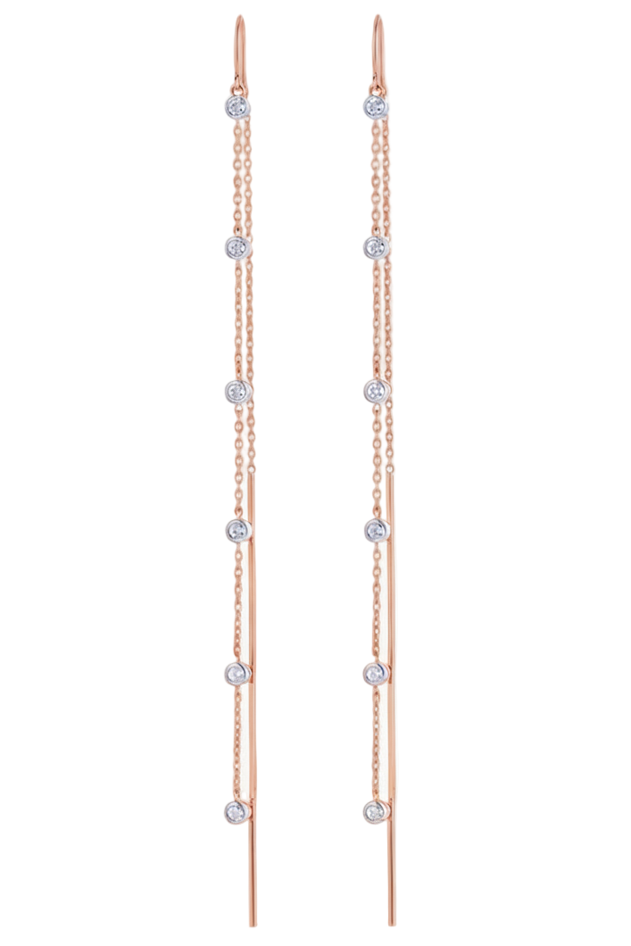 Pair of rose gold earrings with clear gemstones on a white background