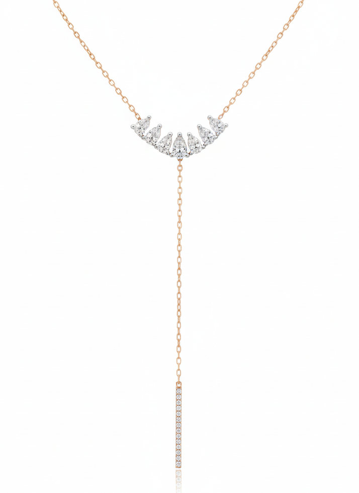 Rose gold necklace with diamond fringe on a white background
