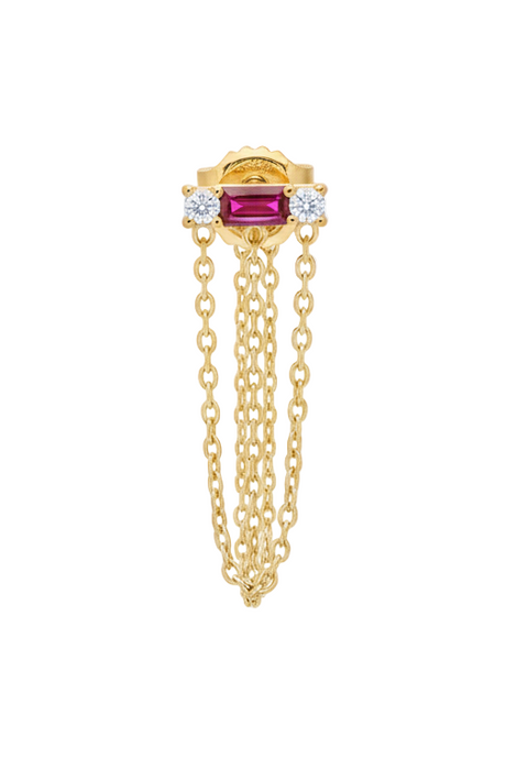 Gold earring with a red gemstone and chain on a white background