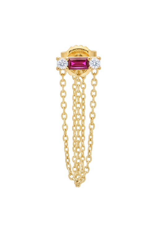 Gold earring with a red gemstone and chain on a white background