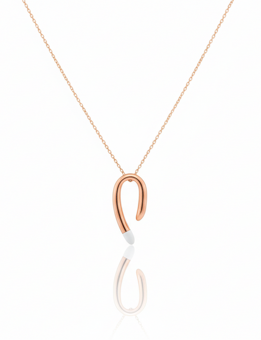 Rose gold hook-shaped pendant on a white background