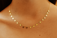 Load image into Gallery viewer, Gold necklace with leaf-shaped pendants on a person&#39;s neck
