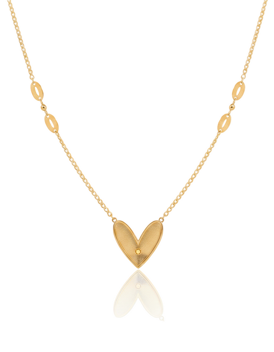 Gold necklace with a heart-shaped pendant on a white background