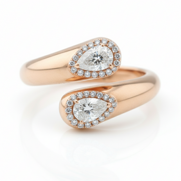 Rose gold ring with pear-shaped diamond on a white background