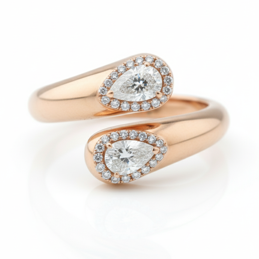 Rose gold ring with pear-shaped diamond on a white background
