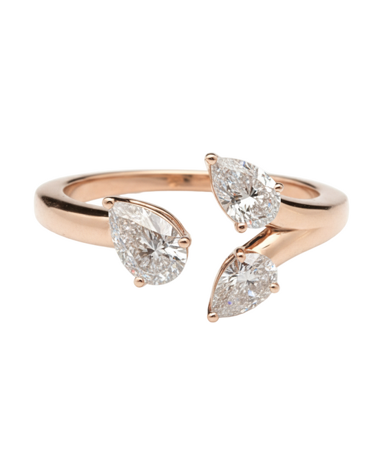 Rose gold ring with three pear-shaped diamonds on a white background