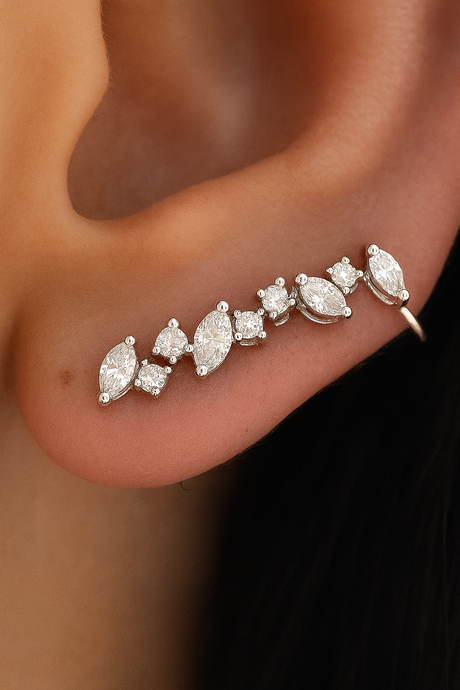 Close-up of a diamond earring on an ear with a blurred background