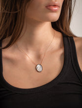 Load image into Gallery viewer, Necklace with a round pendant worn by a person

