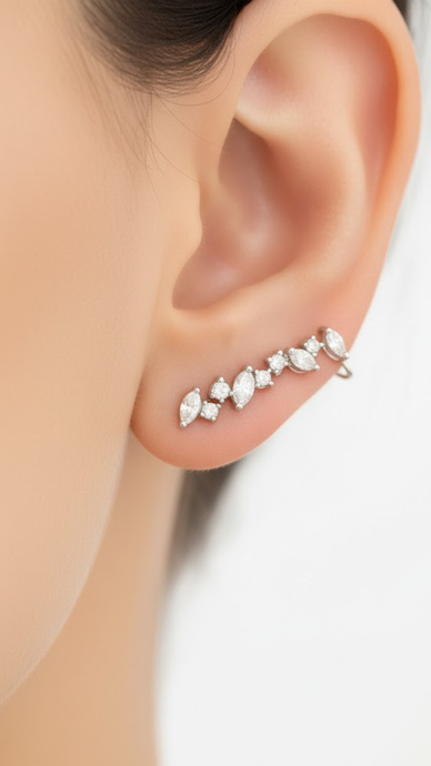 Close-up of an ear wearing a diamond earring on a white background