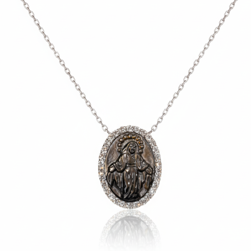 Silver necklace with a religious pendant on a white background