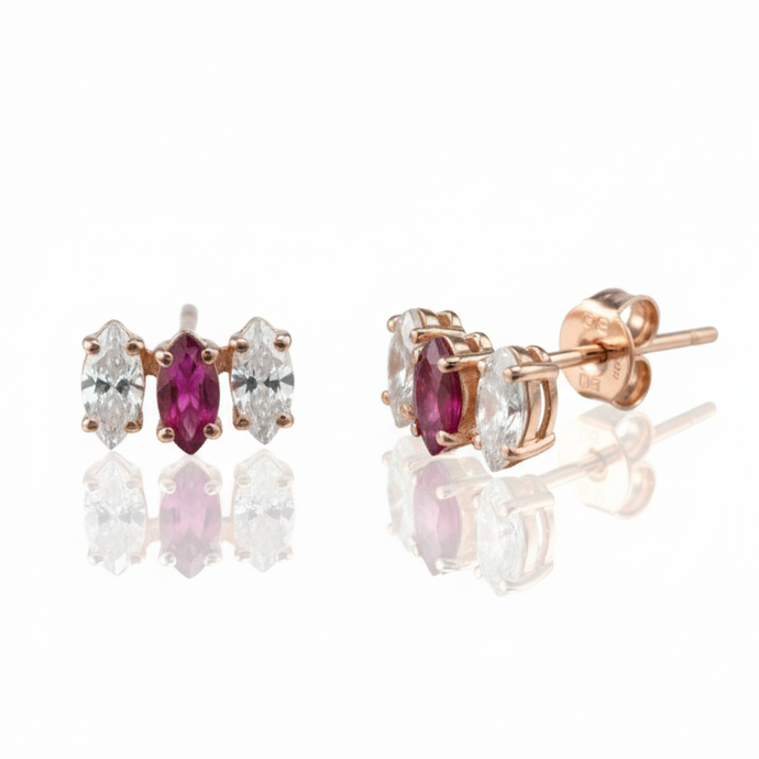 Rose gold earrings with gemstones on a white background
