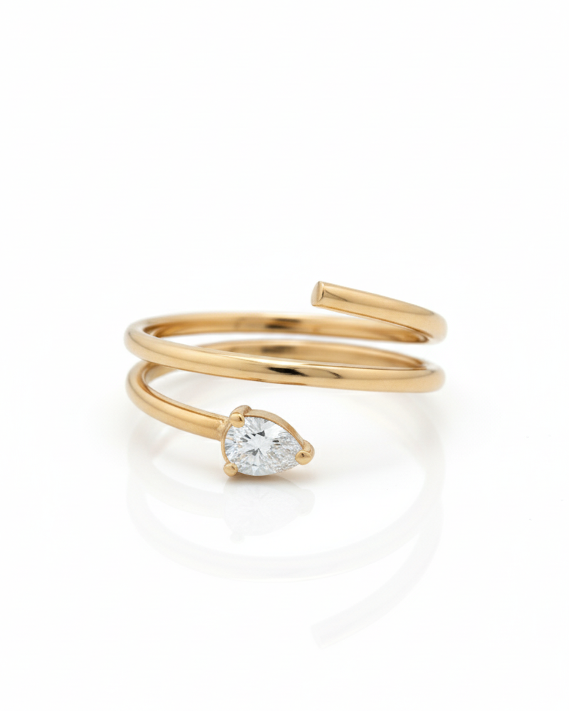Gold ring with a diamond on a white background