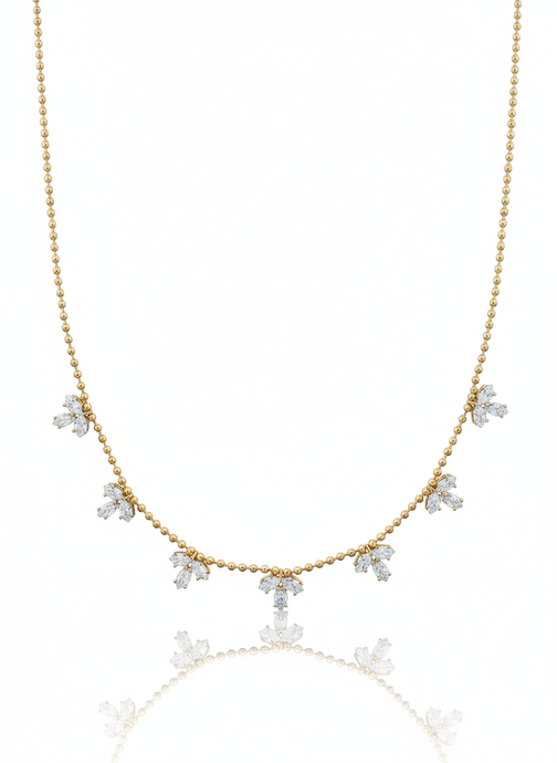 Gold necklace with diamond pendants on a white background